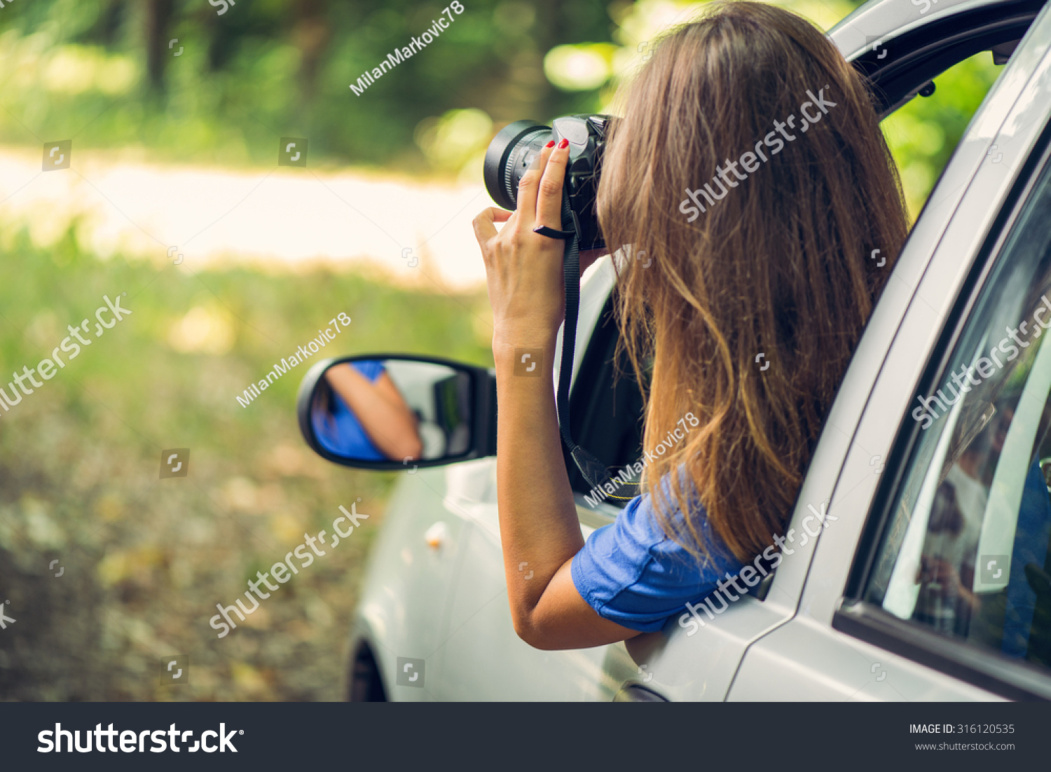 stock-photo-young-beautiful-woman-sitting-in-car-in-the-forest-and-photographing-with-digital-camera-316120535.jpg